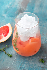 Grapefruit and thyme gin cocktail, refreshing drink with ice