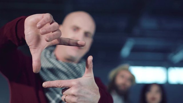 The director aiming with hands for a good frame.