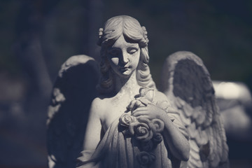 Beautiful angel statue in darkness.