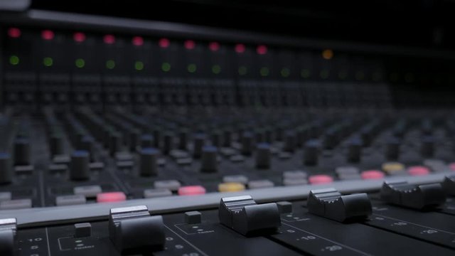 Professional Analog Outboard Audio Mixer With Bouncing Meters With Focus Shift (From foreground to background) in a High-end Studio