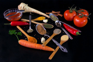 Spices and vegetables on wooden board