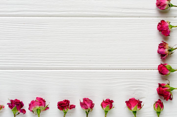 Naklejka na ściany i meble Flowers composition. Pink roses on white wooden background