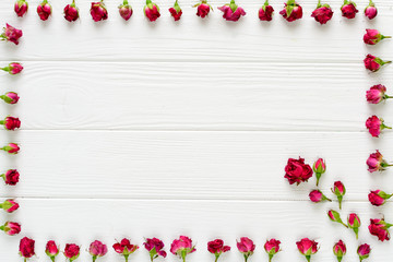 Naklejka na ściany i meble Flowers composition. Pink roses on white wooden background