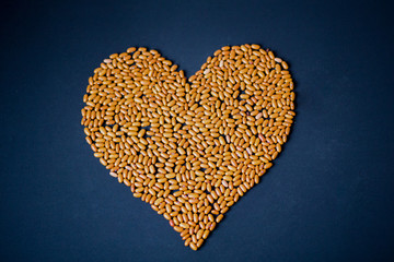 Heart of cereals and pasta on a blue background. Pasta and cereals.