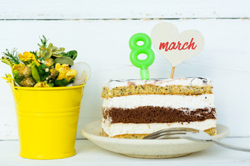 dessert and chocolate candies on a plate with a candle 8, none in shape of heart for text, a bouquet of flowers in a bucket. greeting card Happy Women's Day on eight march  