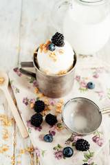 dessert , white ice cream with berries , blackberries and blueberries , milk on the wooden background 