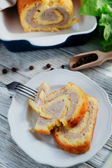 charcuterie, meat, baked chicken roll with egg omelette, peppers, herbs and salad leaves on a white wooden background 