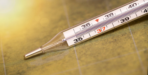 Website banner of fever, cold, flu concept - mercury thermomater closeup