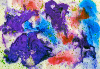 Ink flowing and mixing with colored powder in milk