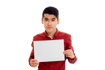 nice young brunette man in red t-shirt with placcard in his hands isolated on white background