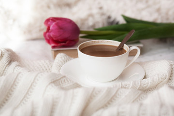 Spring flower and cup of hot coffee