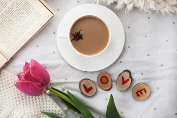 Spring flower and cup of hot coffee