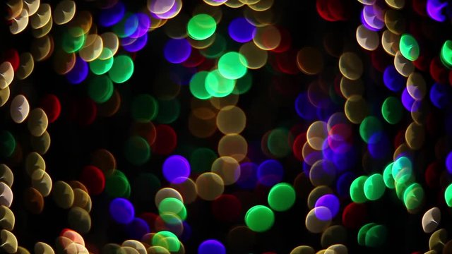 Abstract holiday background with fairy tale blinking lights in magic tunnel. Festive twinkling decoration. Celebration spirit in merry flashing colorful specks on dark night backdrop in full HD clip.