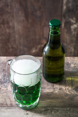 Traditional cold green beer on wooden table for Saint Patrick's Day. Copyspace.