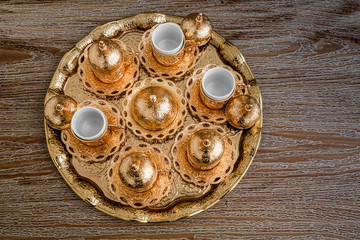 Traditional Golden Coffee Cup Set in a Tray on Wooden Background