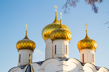 Golden domes church on a background of blue sky