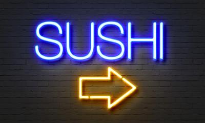 Sushi neon sign on brick wall background.