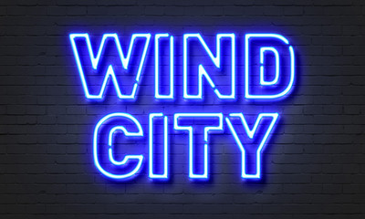 Wind city neon sign on brick wall background.