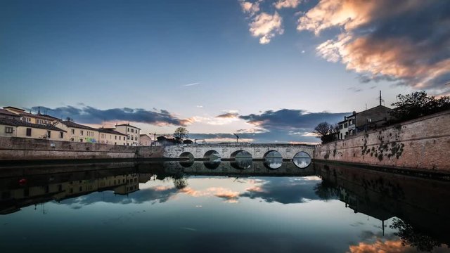Timelapse sunset on Rimini tiberius bridge. City landscape 4K UHD 