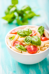 plate of penne pasta with tomato
