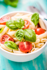 plate of penne pasta with tomato