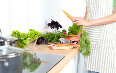 Fresh vegetables on the cutting board are falling in the pot, concept of cooking