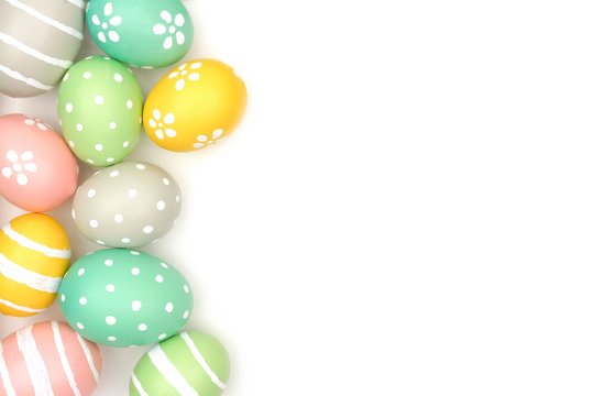 Side border of hand painted pastel Easter eggs over a white background