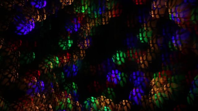 Abstract mystery background of blinking lights with complex web pattern. Blinking and weaving multicolor decoration. Celebration flashing colorful specks on dark night backdrop in fancy full HD clip.