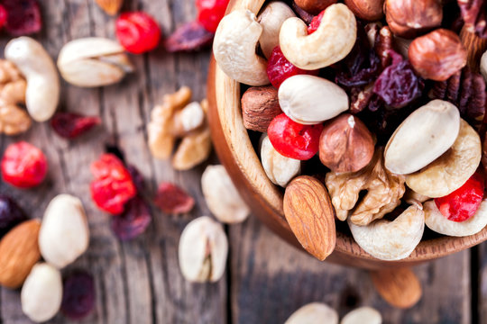 Nuts and dried fruit mix. Concept of Healthy Food. Vintage wooden background. Copy space for Text. selective focus