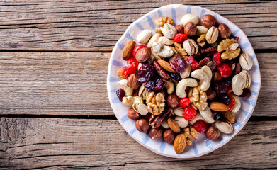 Nuts and dried fruit mix. Concept of Healthy Food. Vintage wooden background. Copy space for Text. selective focus