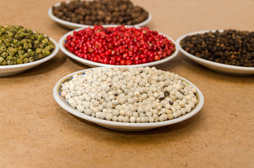 5 peppers on the plate focusing white