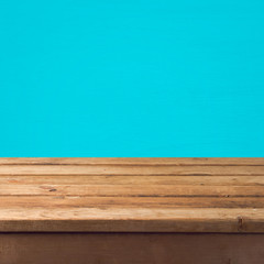 Empty wooden old table over blue wall background for product montage display
