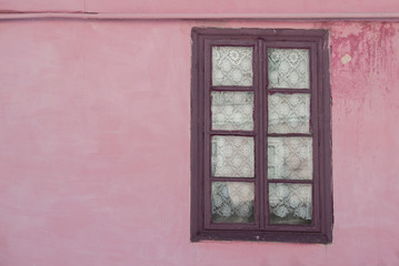 
Fragment of the side wall with old window and a gas pipe over it.