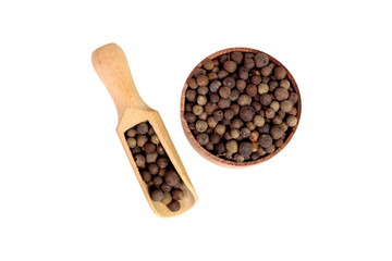 allspice in a small wooden scoops. Black pepper. Spice. isolated on white background.