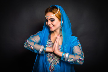 East girl on a dark background