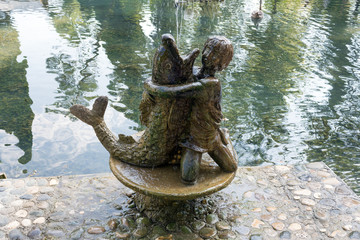 Abkhazia, monument in New Athos park: a boy hugs fish