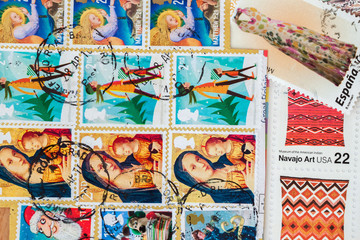 Old used postage printed stamps from various countries as background. For pattern, wallpaper, banner design