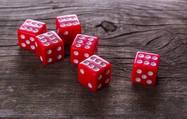 red dice on a wooden table