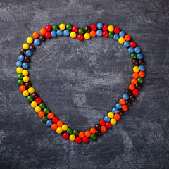 Background of Bright Colored Candy in the shape of a Heart.Holiday Valentine's Day.Holiday Valentine's Day.top view. Copy space. selective focus.