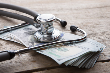 health insurance concept - stethoscope over the money - obrazy, fototapety, plakaty