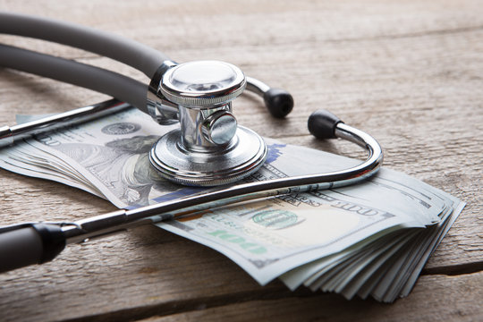 health insurance concept - stethoscope over the money