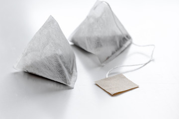 Pyramid teabags on white table mock-up