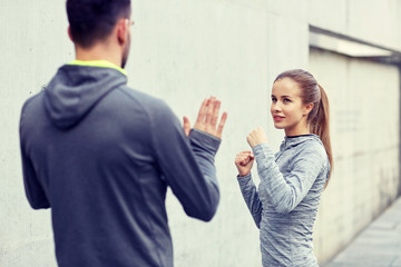 happy woman with coach working out strike outdoors