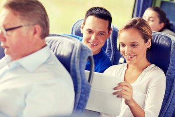 happy couple with tablet pc in travel bus