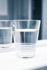 Glass of water stand near the mirror