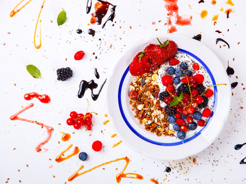 Oatmeal,Granola,Porridge with Yogurt in the  bowl.Detox. Breakfast  with  fresh berries  and nuts,honey and chia seeds.Concept of Healthy Food. selective focus.