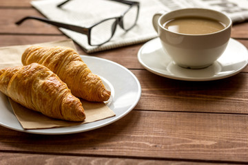Businessman morning cup of coffee at home with newspaper