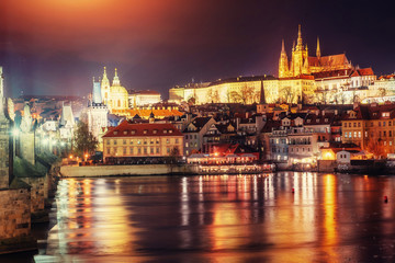 view of Prague castle from Charles bridge at night