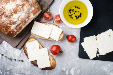 Sliced  ciabatta bread  with  feta cheese and tomatoes.