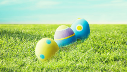 Fototapeta premium close up of colored easter eggs on grass